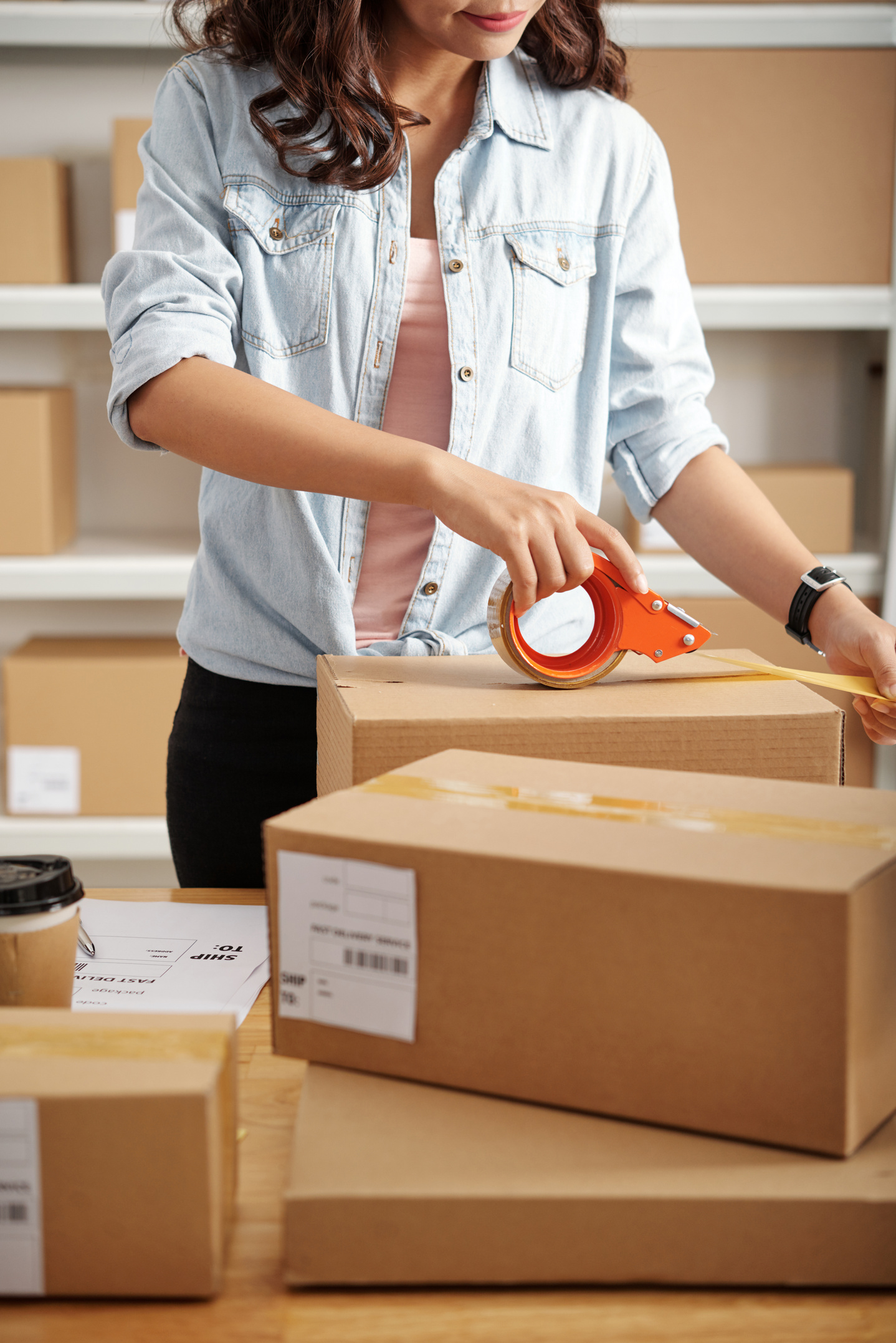 Woman Packing Parcels to Ship